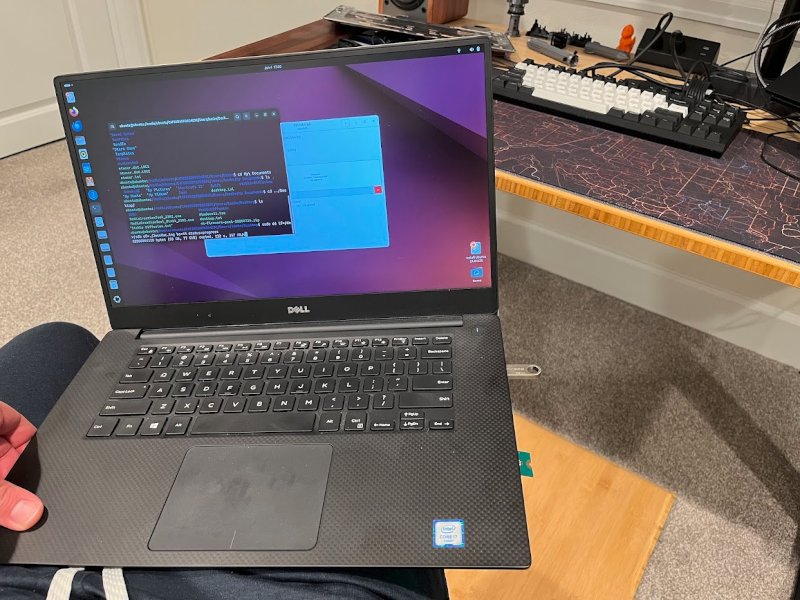 A running laptop with a M.2 adapter hanging off the back